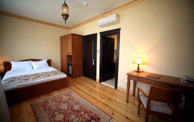 Slaapkamer met bed en bureau hotel Lallin stedentrip Istanbul