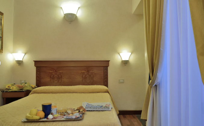 Slaapkamer in hotel Porta Faenza