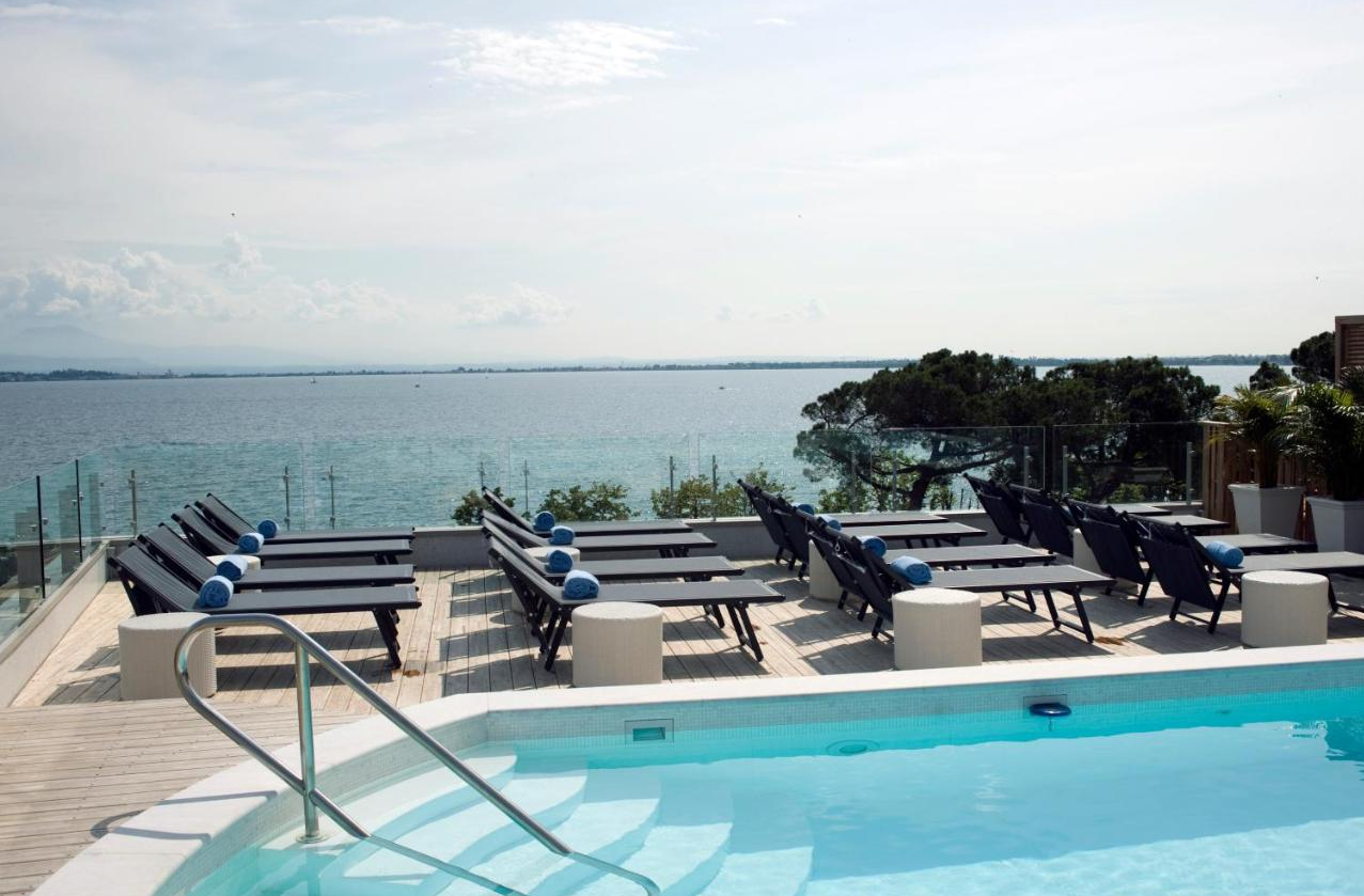 Zwembad met zonneterras van Park Hotel Gardameer