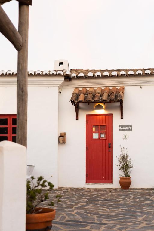 Aldeia da Pedralva - gevel van een dorpshuis met rode deur