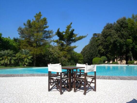 Tuin met zwembad van Resort Borgo Di Colleoli in Toscane